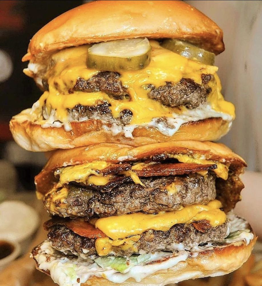 A towering double-stacked cheeseburger